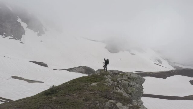 Solitary adventurous hiker alone in cold unexplored and uninhabited land