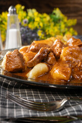 Beef stew in gravy, served with potato dumplings.