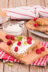 Rye bread with cottage cheese and raspberries.