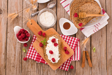 Rye bread with cottage cheese and raspberries.