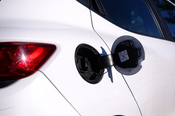 open fuel tank cap of a white car