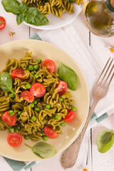 Fusilli pasta with cherry tomatoes and peas.