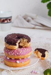 Stack of donuts in colorful glaze on a white background. Dessert and food concept.