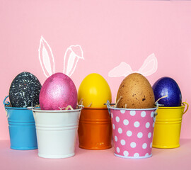 Easter eggs with bunny Rabbit ears in colored buckets, selective focus image, Card Happy Easter	