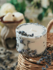 Handmade candle with lavender flowers. Beautiful handmade candle. Relaxation atmosphere. Luxurious lifestyle.