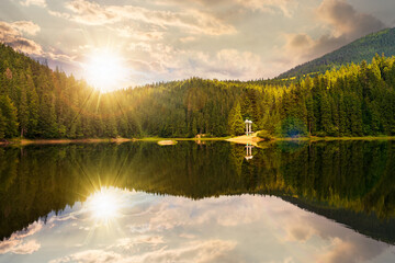 tranquil landscape with lake in summer at sunset. forest reflection in the calm water. scenic...
