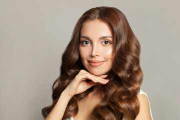 Naklejka premium Portrait of a beautiful young woman with Long wavy hair, healthy clear skin and gentle smile
