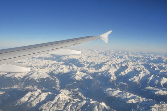 Airplane's wing during a flight over the Alps