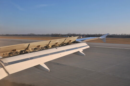 Airplane wing during plane landing at airport
