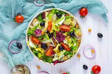 Vegetarian salad with chickpeas, tomatoes, olives and lettuce. Diet salad food