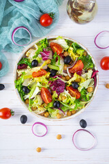 Vegetarian salad with chickpeas, tomatoes, olives and lettuce. Diet salad food