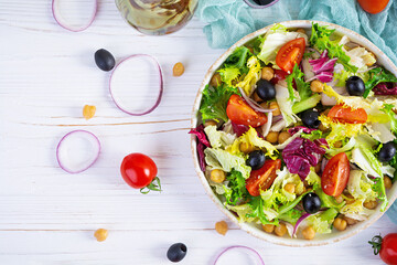 Vegetarian salad with chickpeas, tomatoes, olives and lettuce. Diet salad food