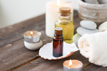 Assortment of natural oils in glass bottles on wooden background. Concept of pure organic ingredients in cosmetology. Bath accessoiries, atmosphere of harmony, relax. Close up macro. Healthy lifestyle