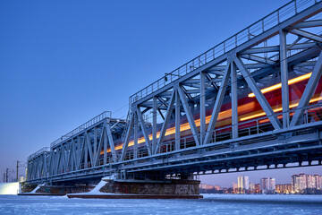 Fototapeta premium Train movement across the Railway bridge in Voronezh in winter