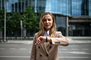 Business woman checking the time on her watch