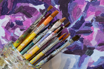 brushes in watercolor paint on an isolated background closeup ,hobby and creativity