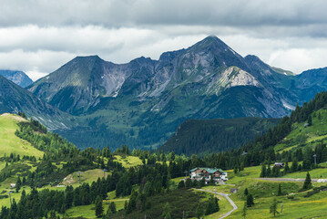 Sunny mountain landscape - meadows, forest, ski lifts, houses, roads,  in alpen ski resort Obertauern in summer, Radstadter Tauern, Austria. - 485200045