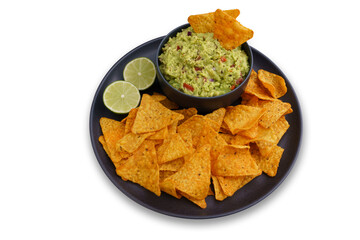 Top view of guacamole sauce and tortilla chips or nachos in black plate isolated on a white background
