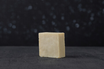 Natural white organic soap box in front of black background
