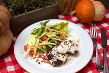 Steak with Creamy Peppercorn Sauce. Fresh salad on the side. Chateaubriand of tender beef and cream sauce with peppers.