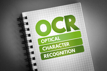 OCR - Optical Character Recognition acronym on notepad, technology concept background