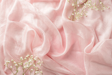 Top view photo of the big and nice branches of gypsophila on the pastel pink isolated and textile background blank space