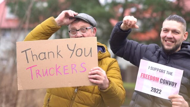 Portrait of people with posters Thank you truckers and Freedom convoy on every Sunday march against lockdowns and vaccine mandates in a Canada