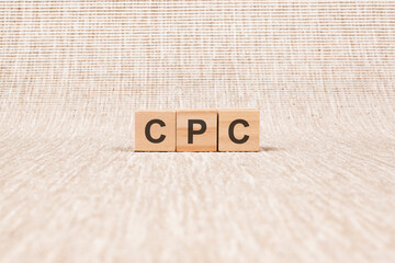 CPC word written on wood blocks. text on broun backgrond for your desing, concept