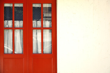 Fototapeta premium Antique red door and white exterior wall