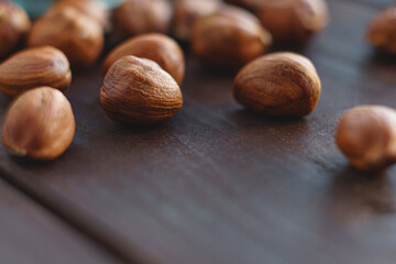 Macro of brown hazel nut on wooden desk. Healthy organic vegetarian snack hazelnut. Place for text