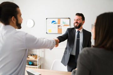 Finance agent making a deal with a young couple