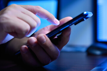 Businessman hands using smartphone in hight office.