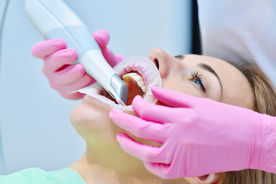 Woman dentist using dental intraoral scanner