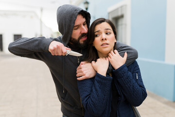 Man forcing a woman to give him money