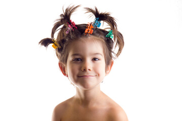 Landscape portrait of funny boy or girl with hair clips on white background.