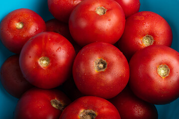 Fototapeta na wymiar Background from farm red, ripe tomatoes. Juicy tomatoes close-up.