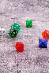 Different colored dice on an abstract cement-like background