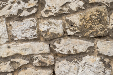 Wall made from irregular-shaped stone blocks. Patterned background or banner