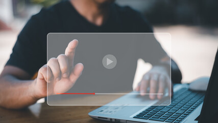 Hands of man using laptop to stream online Watch internet videos,tutorials using your mouse and keyboard to stream online. Watch videos on the Internet, live performances, performances, or tutorials.