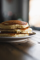 Short Stack of Pancakes on Wooden Table in Morning Light. Cooking Breakfast Lifestyle. 