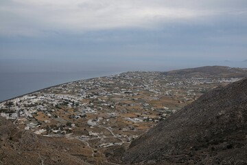 Fototapeta na wymiar Panoramic view of the village of Perissa and the sea from a viewpoint in Santorini Greece