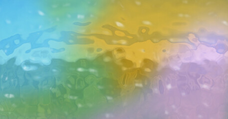 Blurry, soft, abstract colorful background. Wet effect on opal glass plate colored with soft colors: pink, green, light blue and orange.