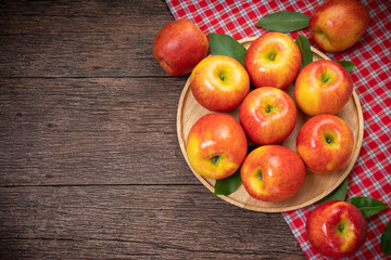 Fototapeta na wymiar Red apple in wooden plate on wooden background, US. Red Envy apple on wooden table.