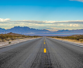 Panoramic image of a lonely, seemingly endless road in the desert