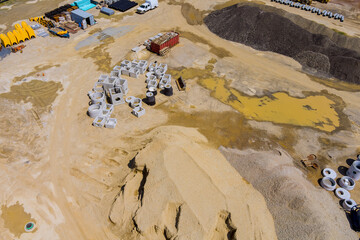Aerial view with stacked concrete drainage pipe in apartment building on construction site