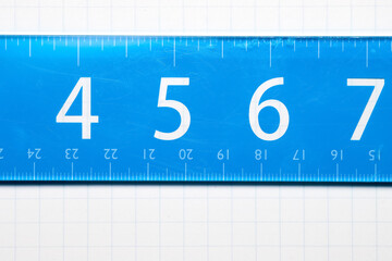 Close up shot of ruler with 4,5,6,7 inches view on the scale, on Graphic paper.