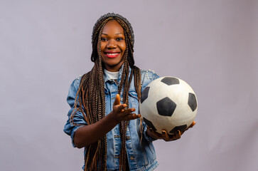 Portrait of confident female goalie pointing to ball