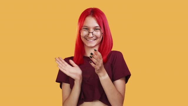 Clapping woman. Proud satisfaction. Congratulation gesture. Boomerang motion. Happy smiling girl applauding in joy isolated on orange free space background GIF loop.