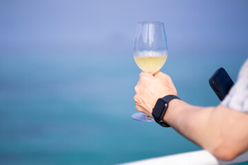 young man relaxing with wine by the sea on vacation