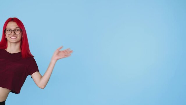 Hi gesture. Greeting sign. Welcome invitation. Friendly cheerful young woman waving hand in hello bye expression isolated on blue copy space background.